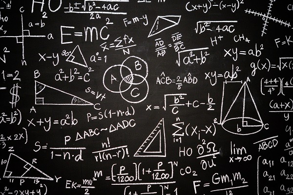 A chalkboard filled with various mathematical formulas and diagrams, including equations like E=mc², algebraic expressions, geometric shapes, a Venn diagram, symbols for limits and summations, and even some intricate calculus problems involving derivatives and integrals