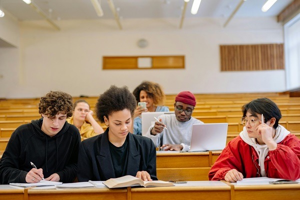 A group of students are sitting in a classroom and they appears to be engage in inorganic chemistry homework and assignment