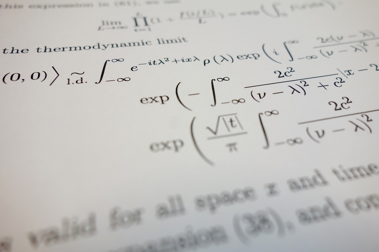 Close-up of a page filled with dense mathematical equations, including integral equations and exponential functions. The text is printed in black on white paper and includes various symbols and variables, indicative of advanced mathematical or scientific notation.